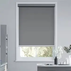 Sleek energy-efficient solar roller shades mounted in a open-concept office space with large windows